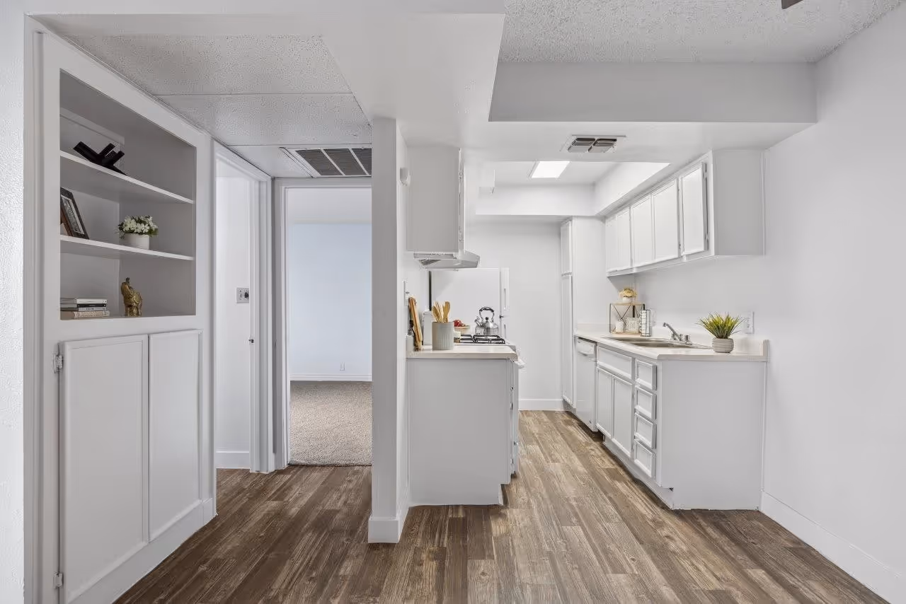 Kitchen with white cabinets and white appliances