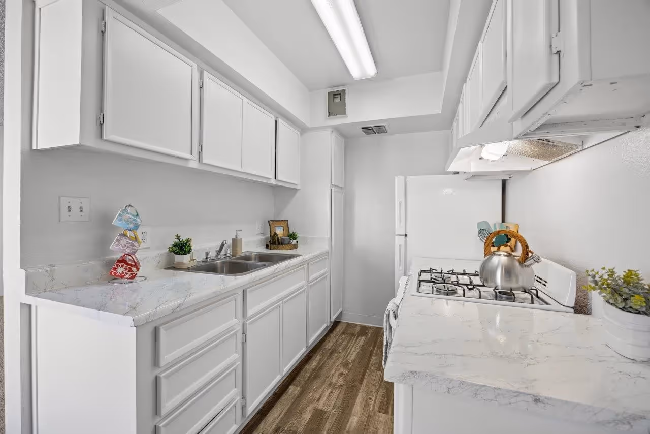 Kitchen with white cabinets and white appliances