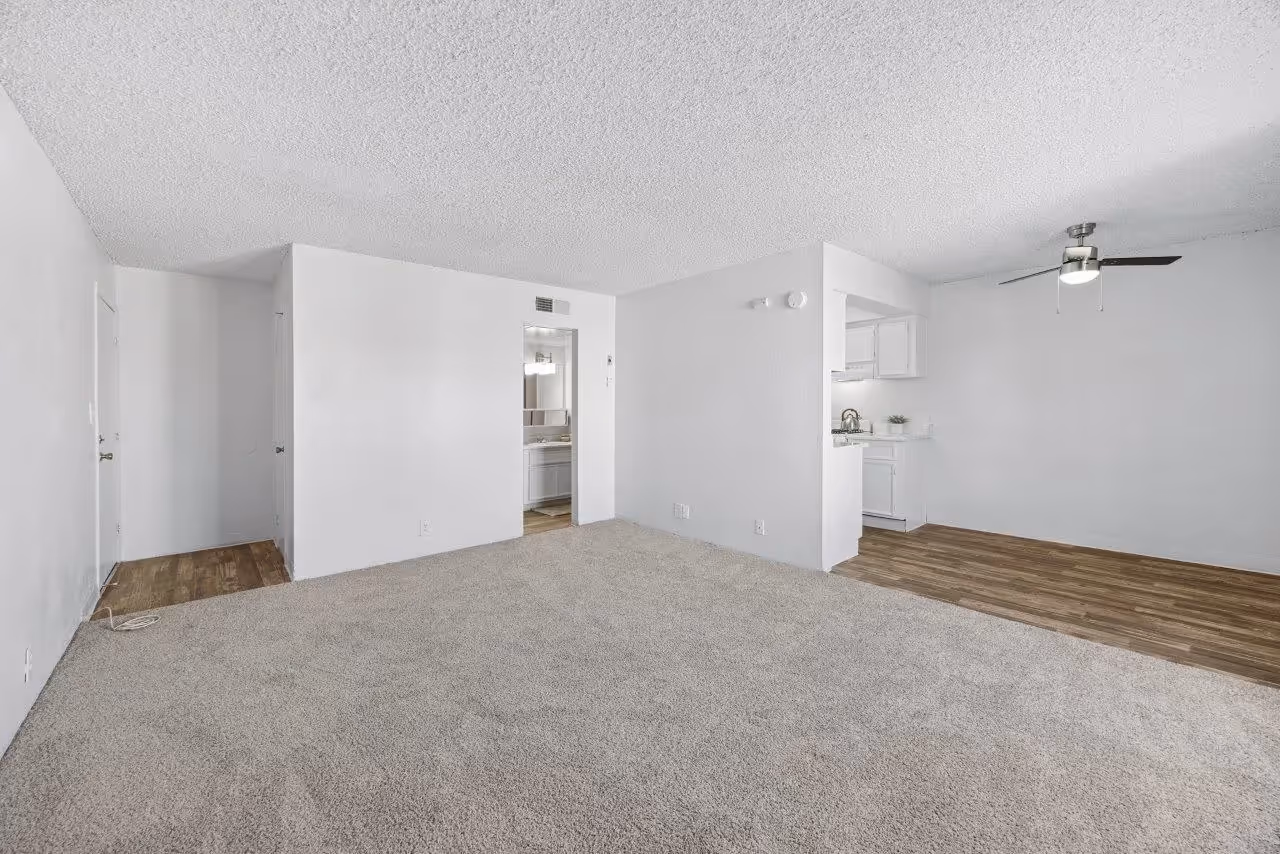 Wide view of living area with carpet and view of dining area