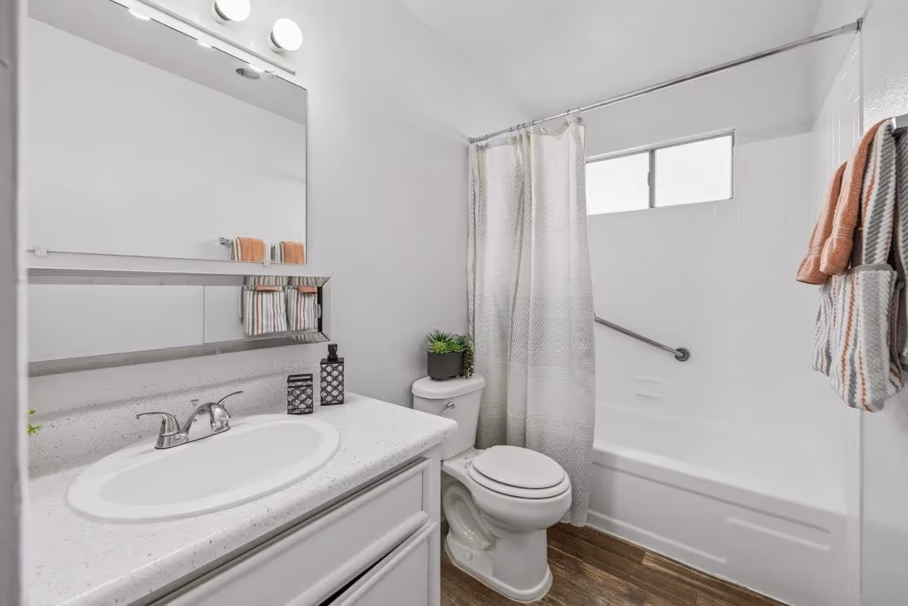 Bathroom featuring shower tub combo, Vanity with sink, mirror, and white cabinets