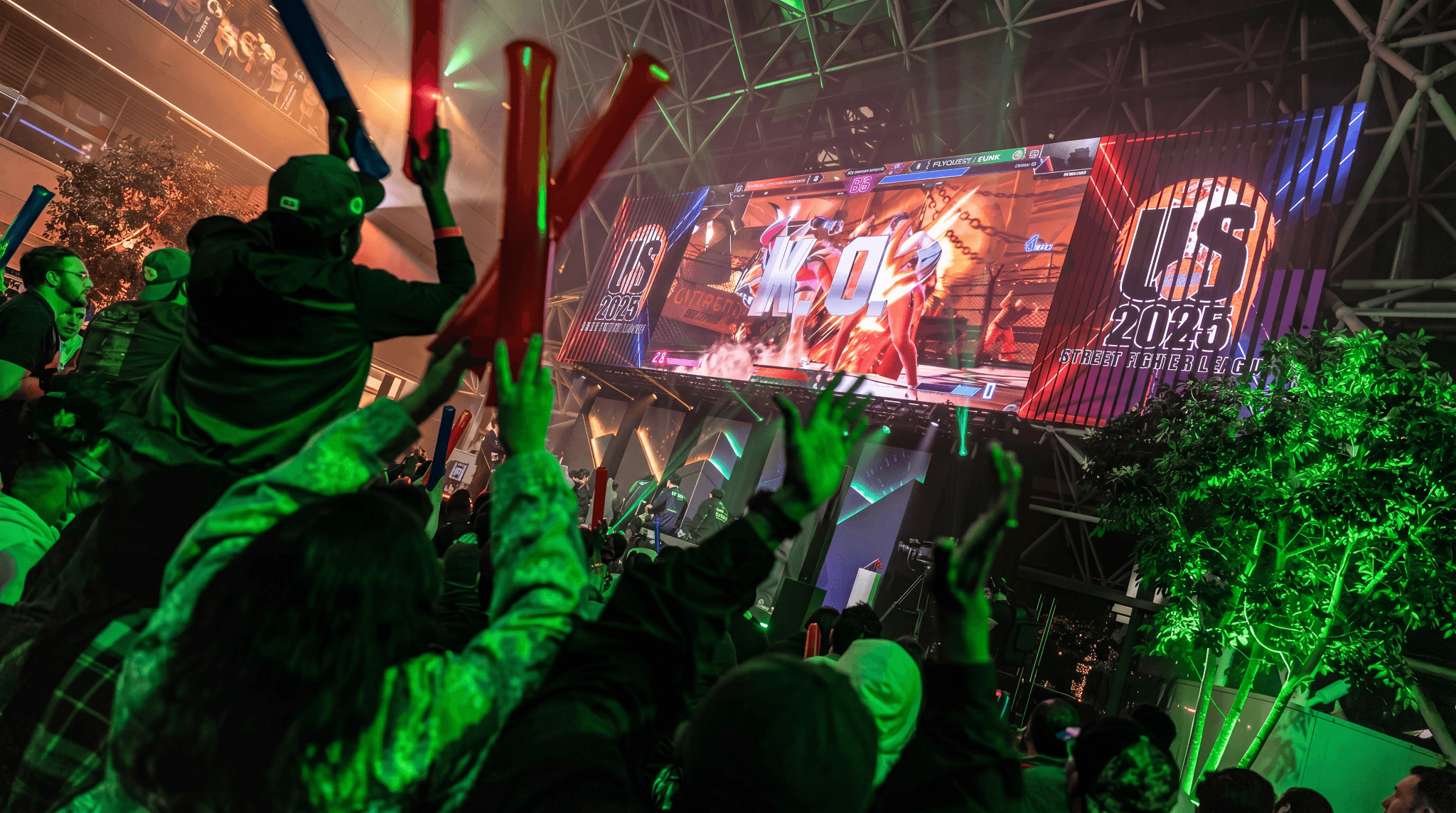 Capcom Street Fighter League US 2025 Finals, with a crowd waving light sticks beneath a giant screen showing a KO moment