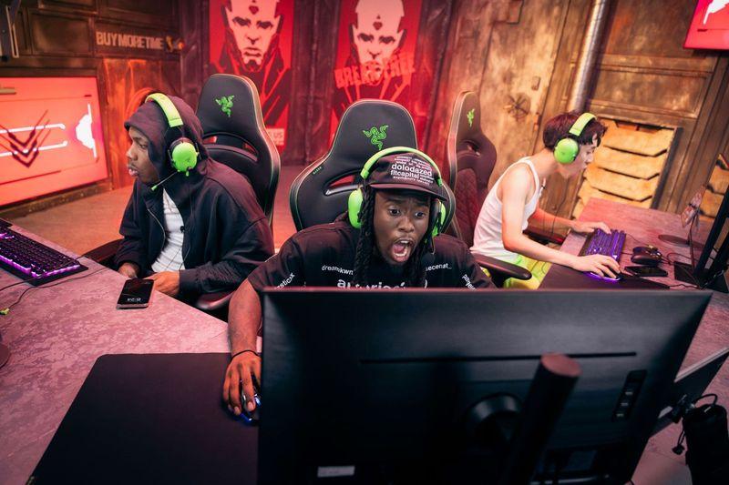 Streamer reacts at a gaming station during the Borderlands 4 Kai Cenat premiere, live stream produced by Blue Coast for Gearbox Software