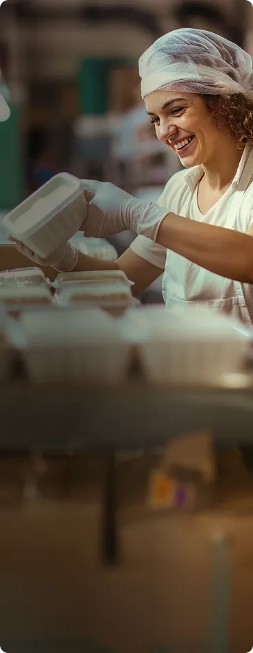 A woman in a white shirt and a white hat.