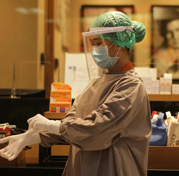 A man wearing a surgical mask and gloves.