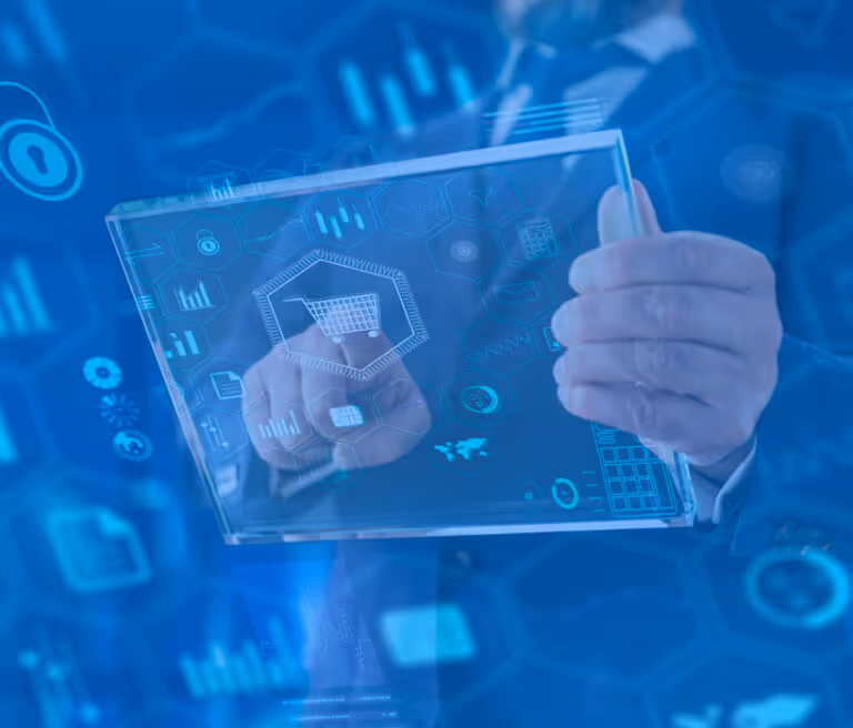 Hands holding transparent tablet with digital shopping cart icon and data graphics in blue theme.