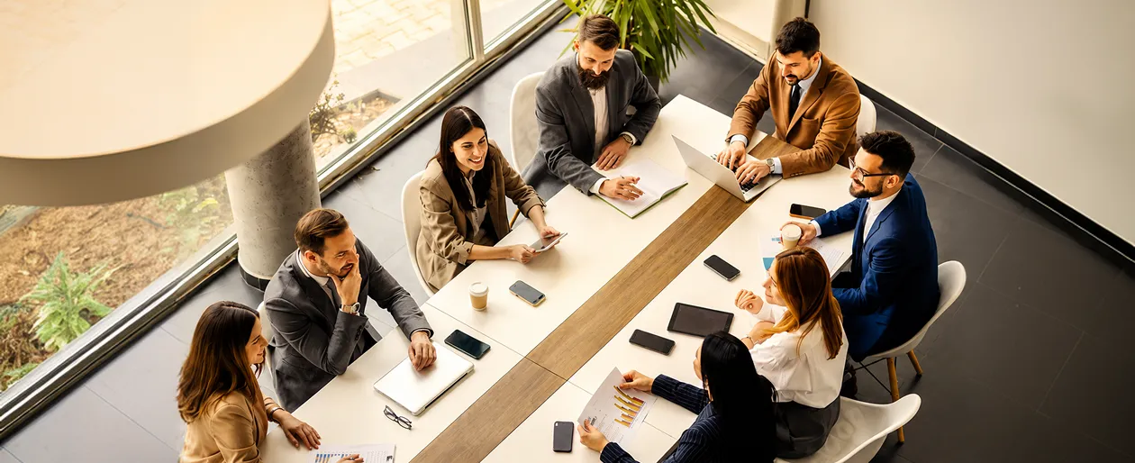 A group of people sitting around a table.