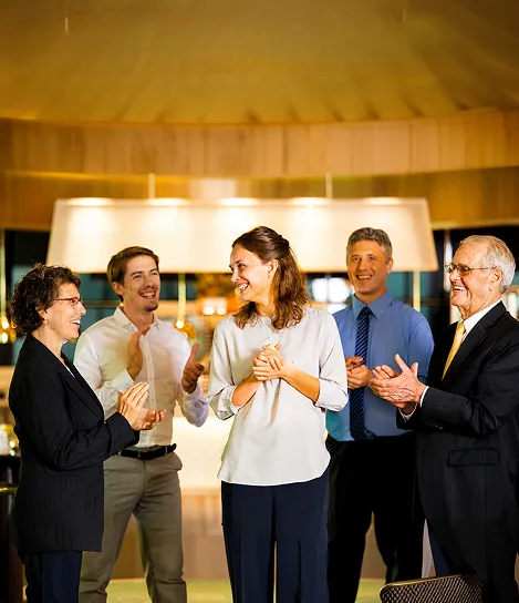 A group of people standing around each other.