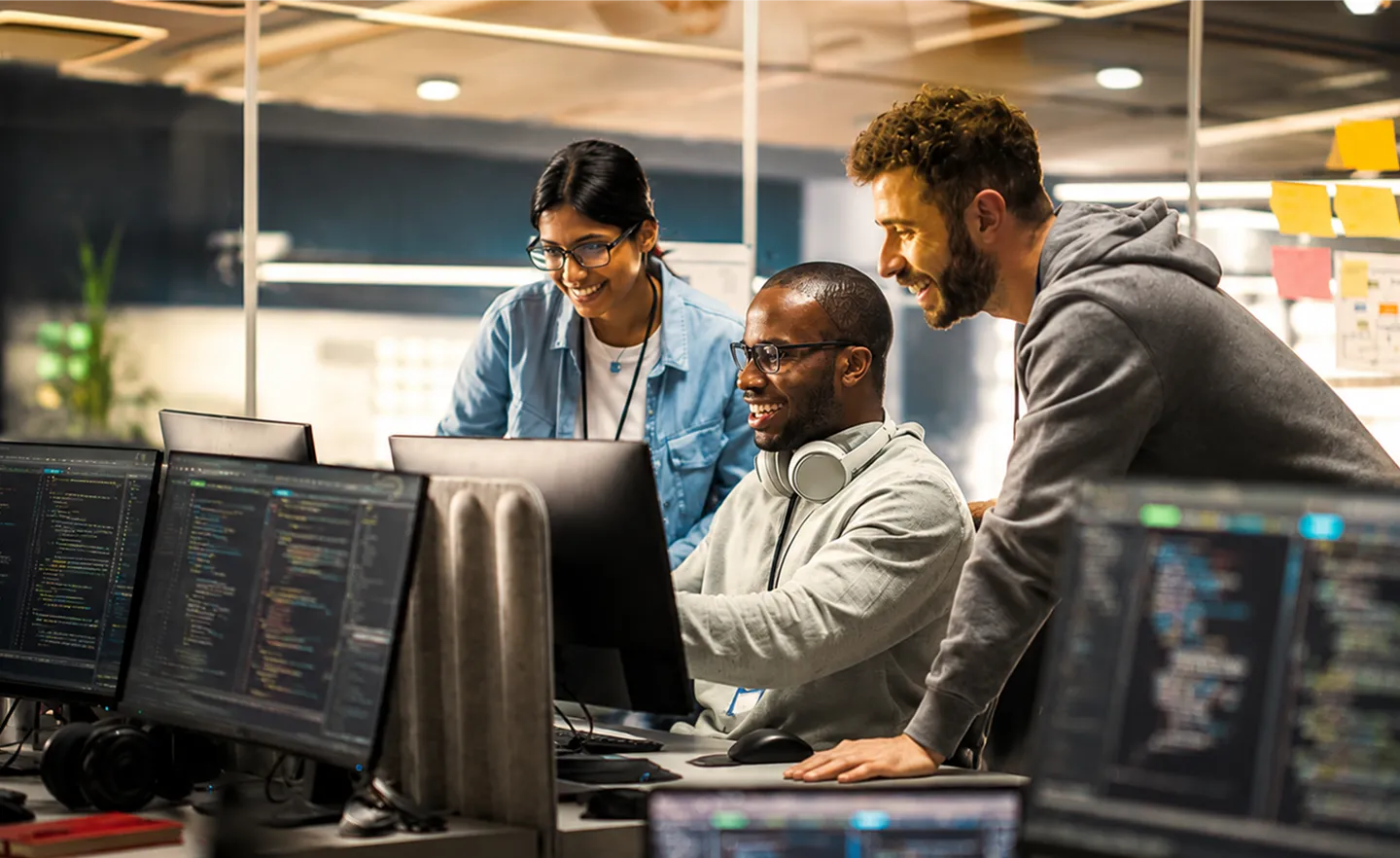 A group of people looking at a computer screen.