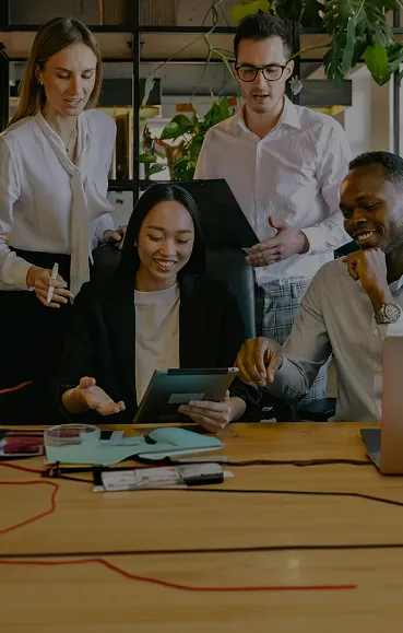 A group of people sitting around a table.