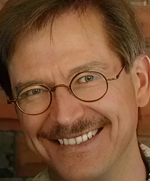 A close up of a person wearing glasses.