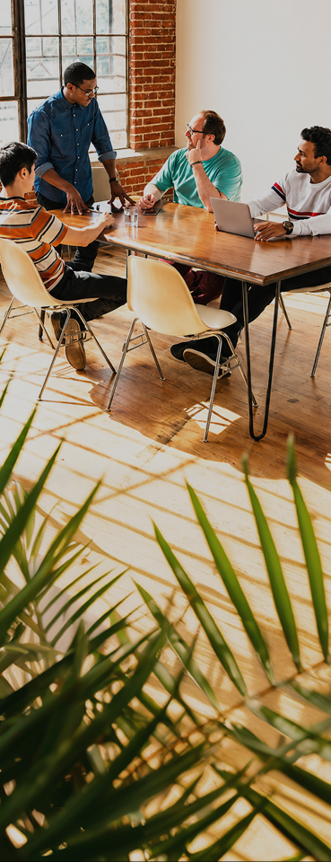 A group of people sitting around a table.