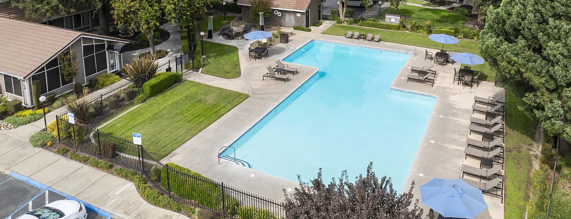 Pool view with louge chiars near building 
