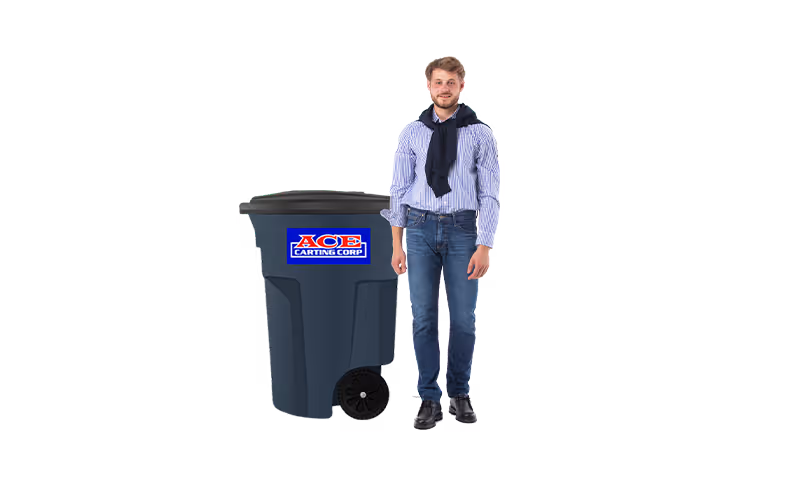 Man in blue jeans and shirt stands next to a large black trash cart with Ace Carting Corp logo.