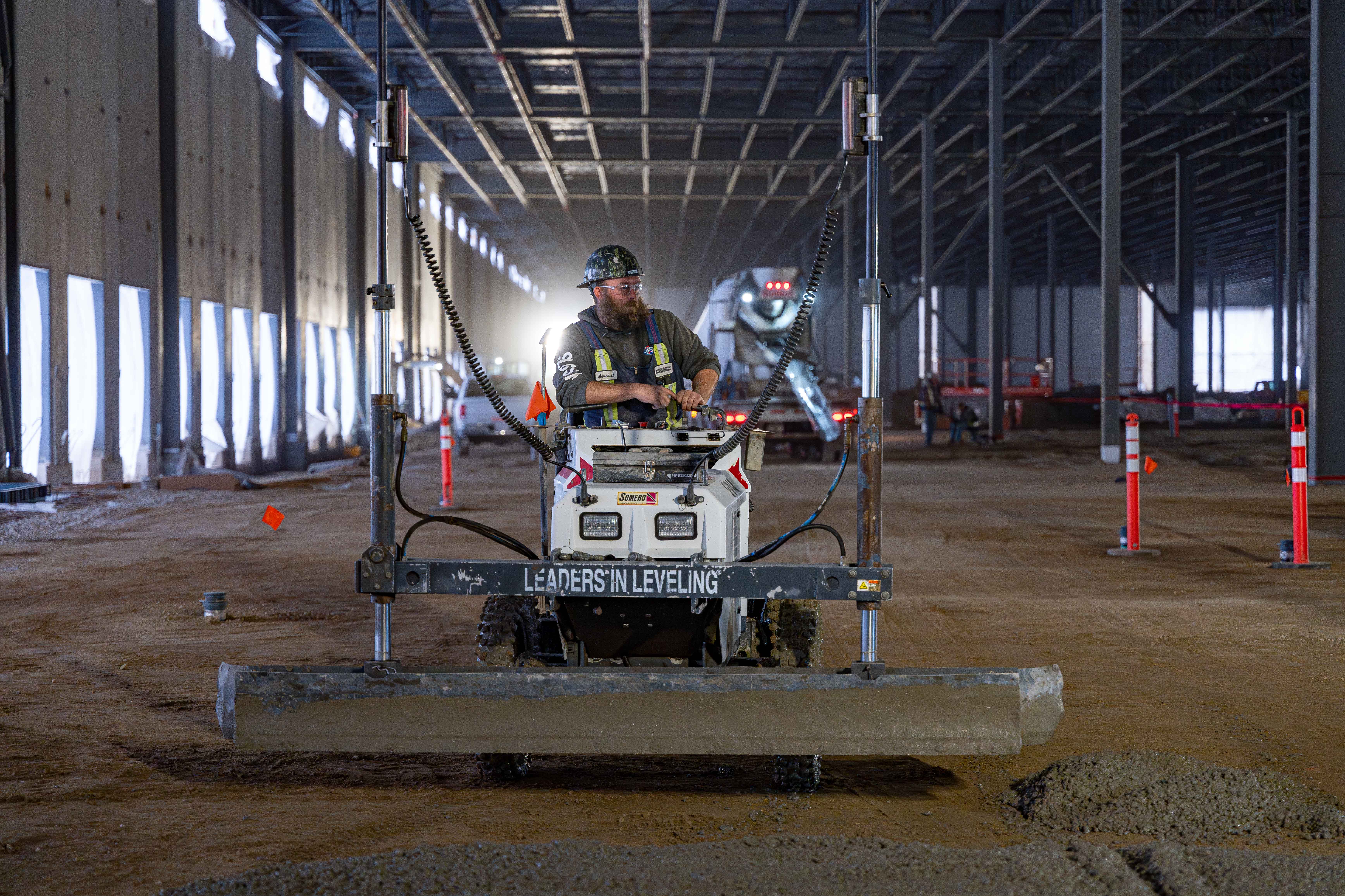 Dynamic Concrete crew running the laser-guided screed