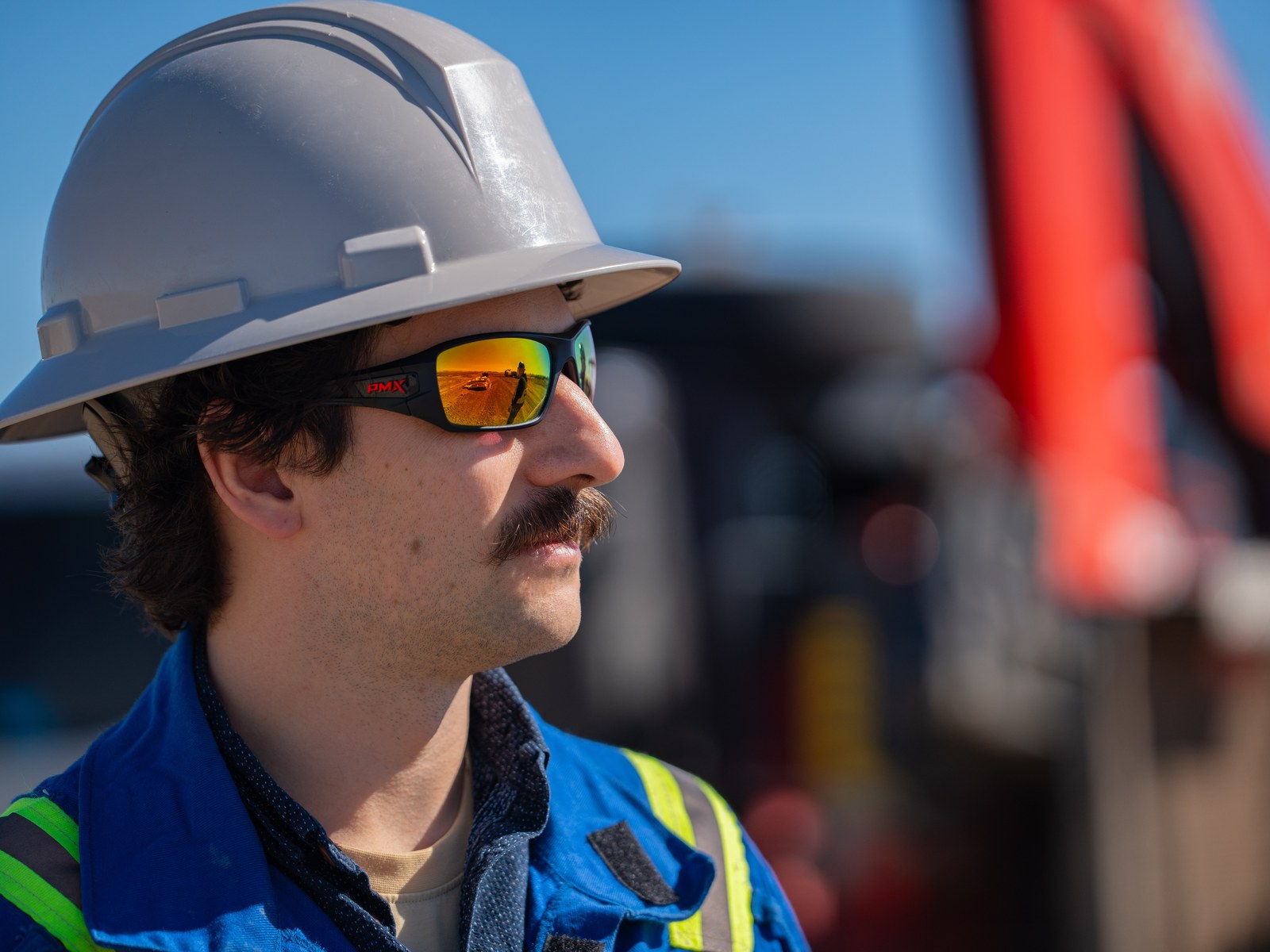 A crew member in a hard hat and safety glasses on the E3 Lithium lease