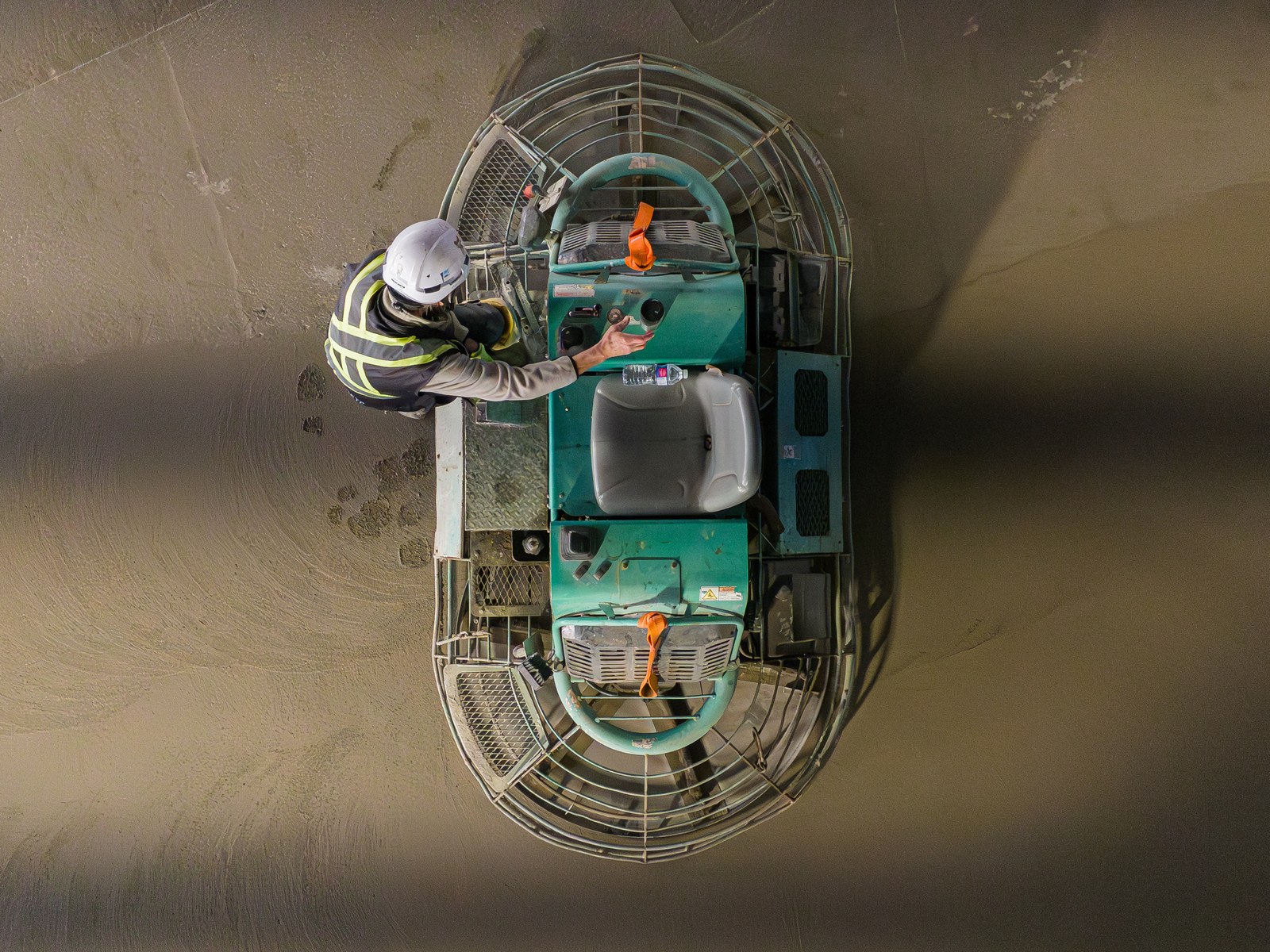 Overhead view of an operator on a ride-on power trowel finishing the Starfield slab