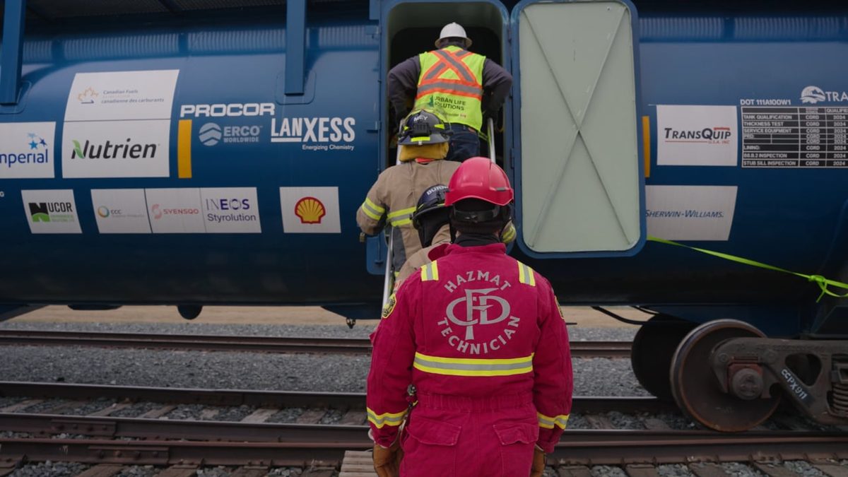 First responders boarding the CCPX 911 training tank car at CPKC HazMat Days, Calgary
