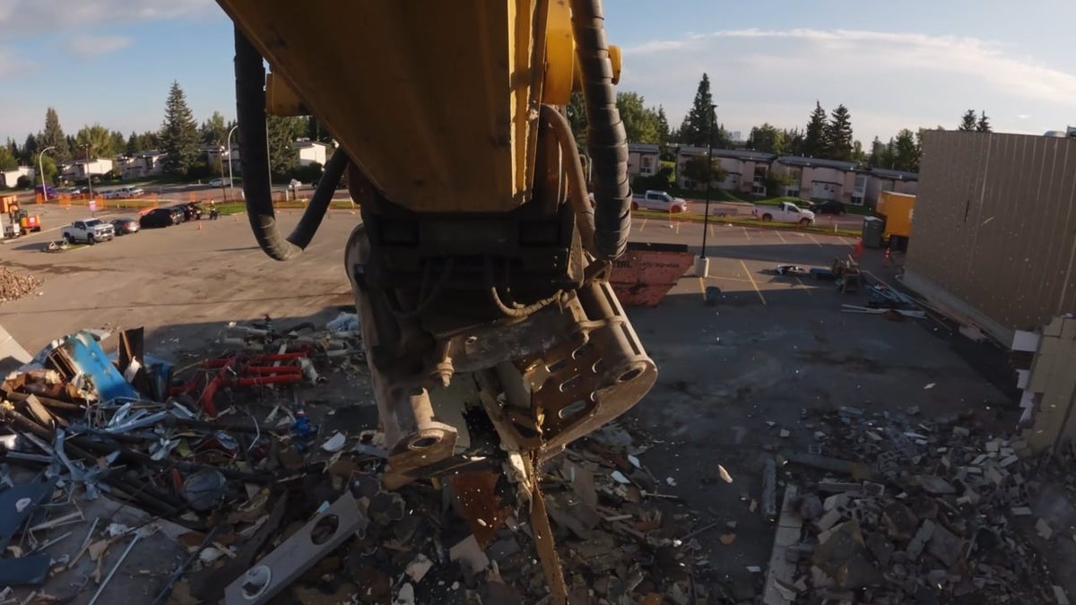 Excavator shear sorting demolition debris at the Oakridge Co-op site in Calgary
