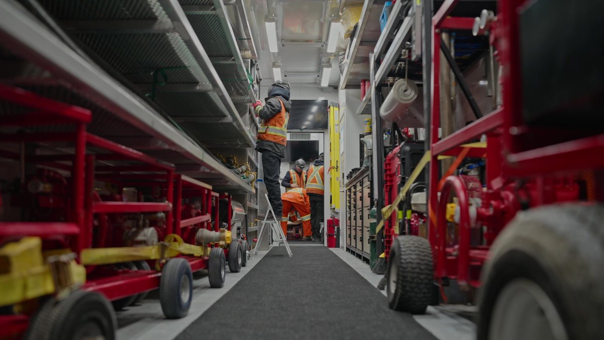 The inside of a CPKC transfer trailer, racked with carts, hose and response equipment