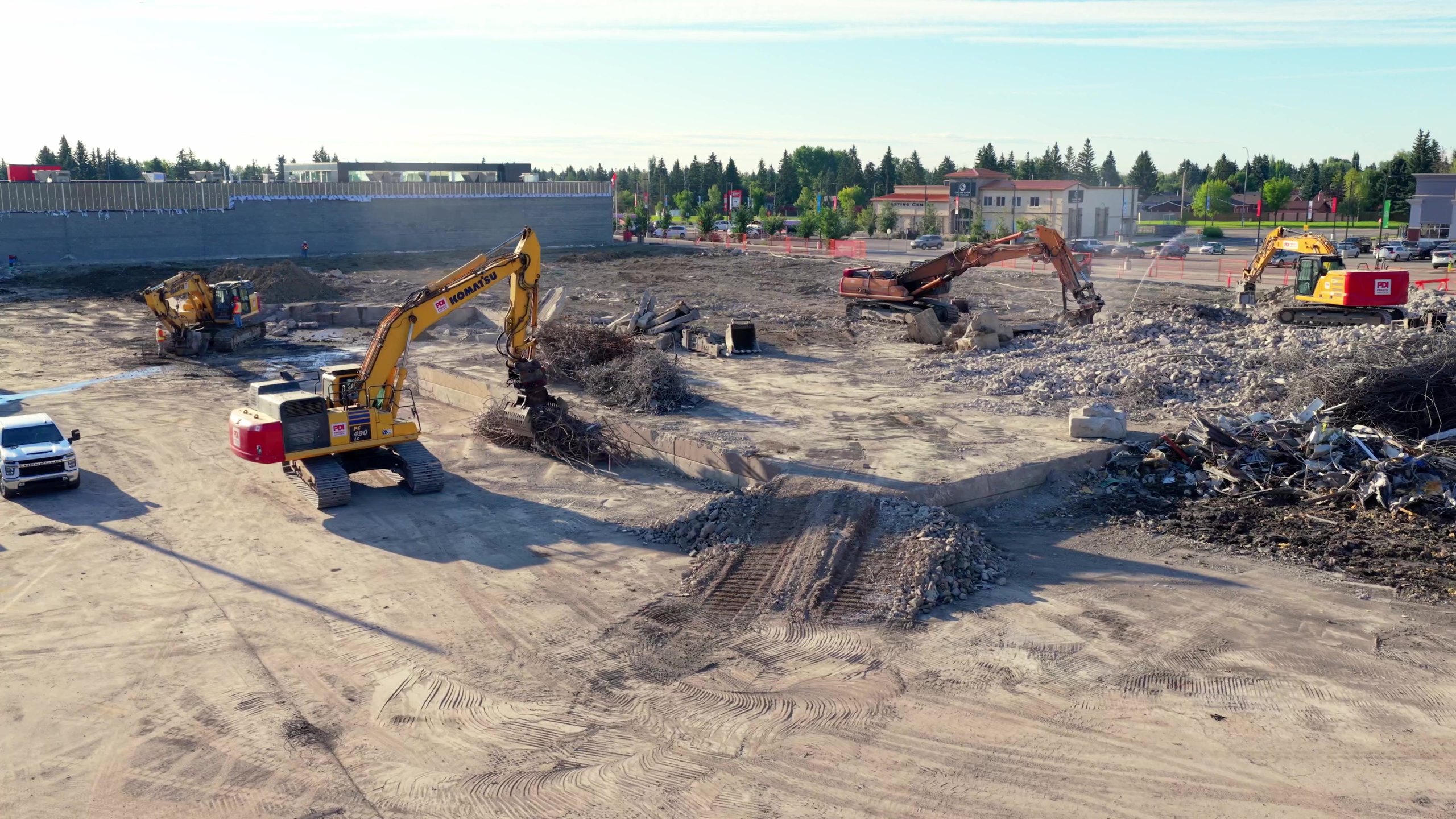 The Oakridge Co-op site mid-demolition, machines working and material sorted into piles