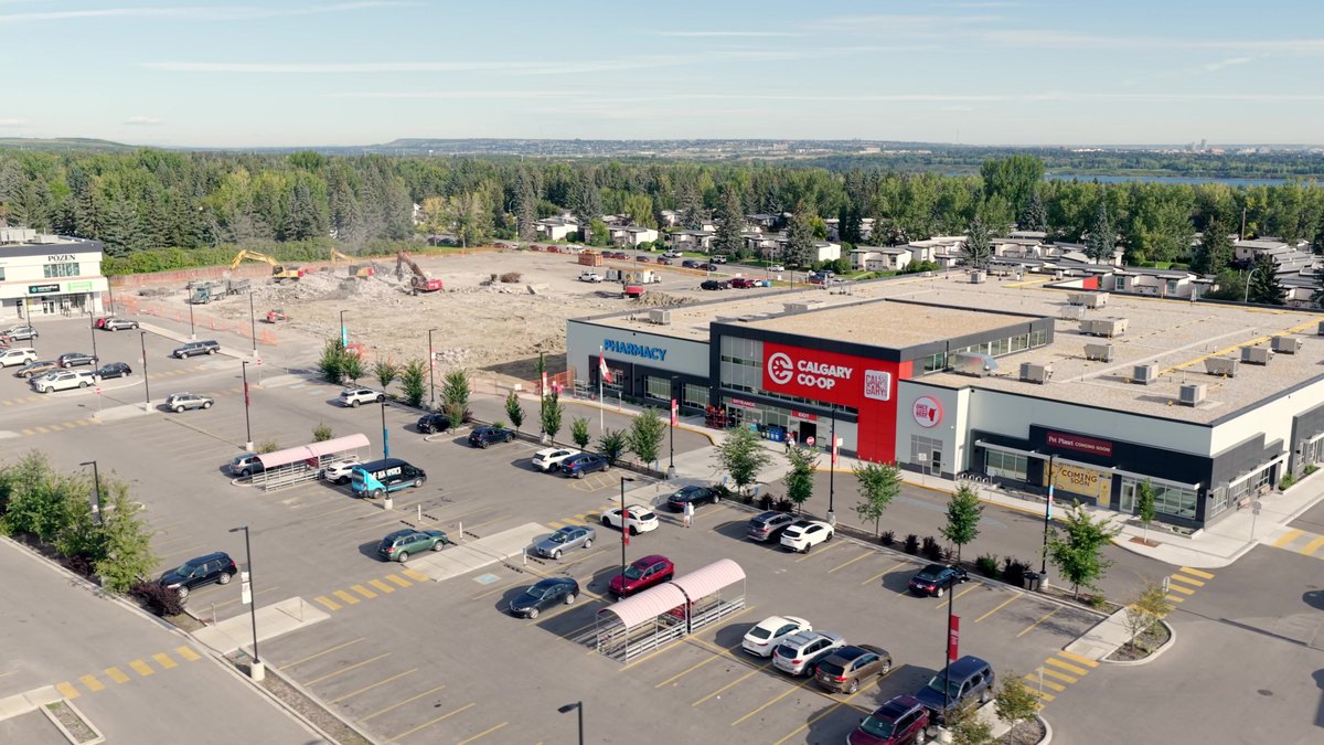 Aerial of the Calgary Co-op store trading while demolition runs on the far side of the lot
