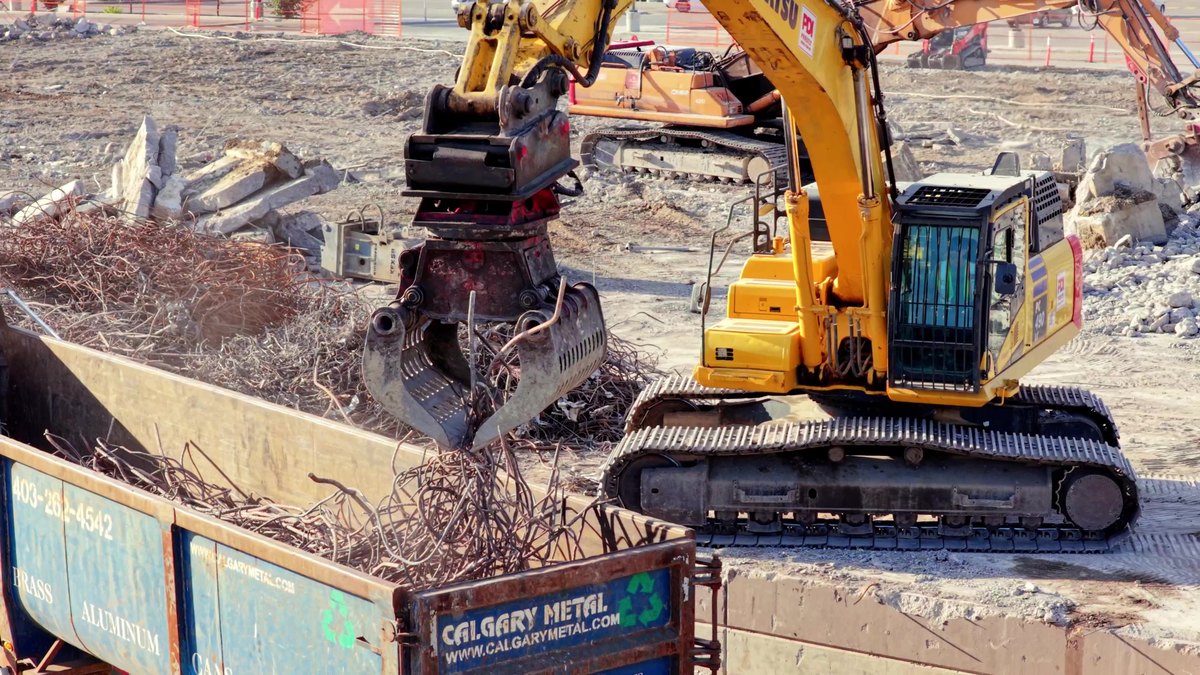 An excavator loading sorted steel into a Calgary Metal bin at the Oakridge site