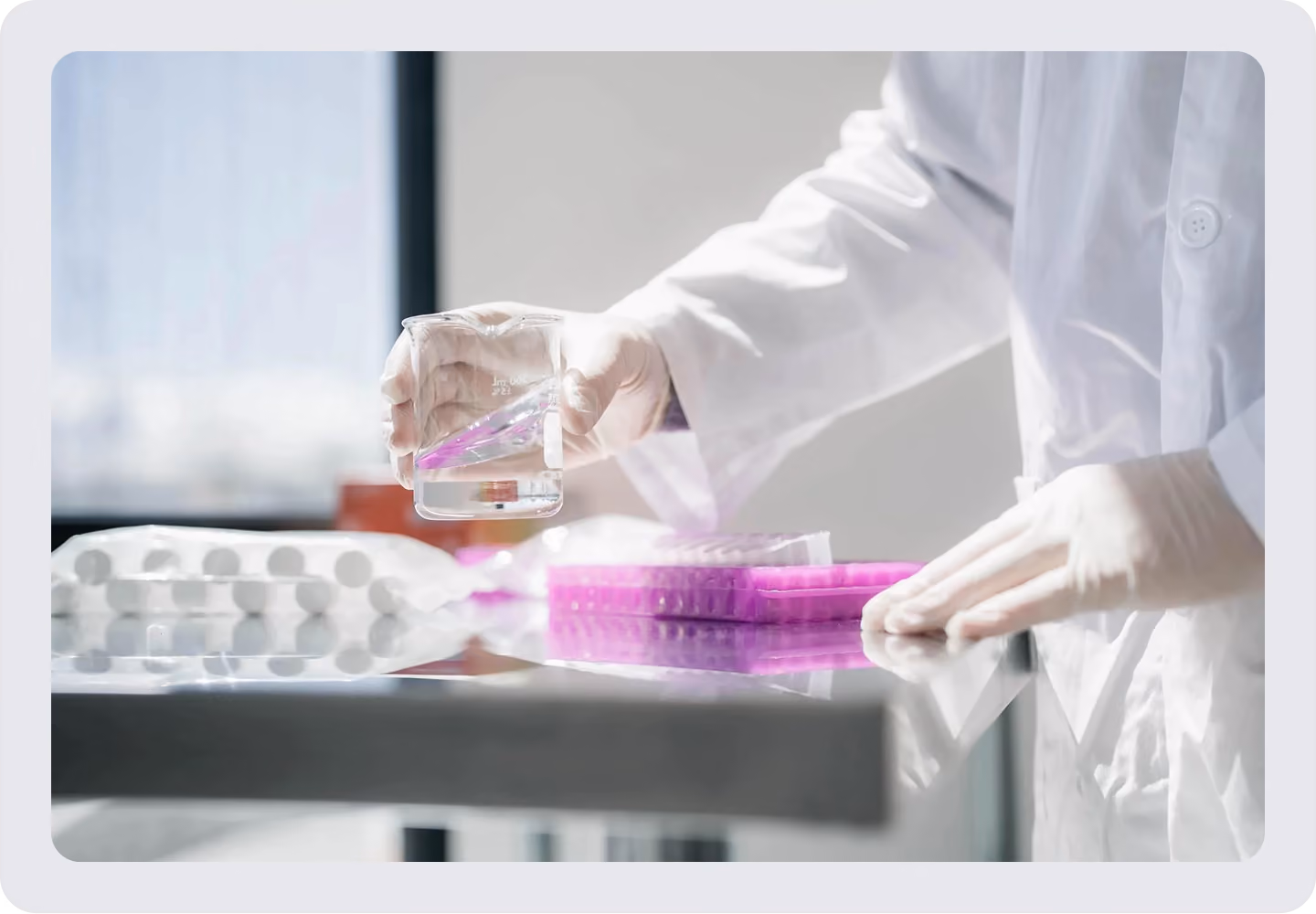 Laboratory researcher handling a sample and microplate during molecular biology analysis.