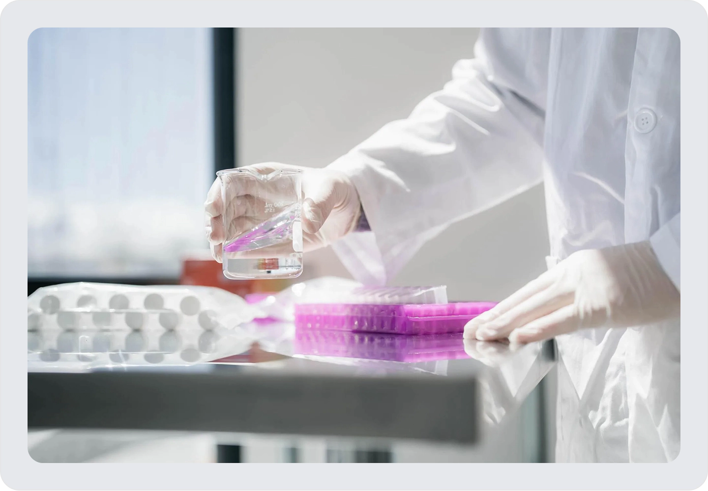 Laboratory researcher handling a sample and microplate during molecular biology analysis.