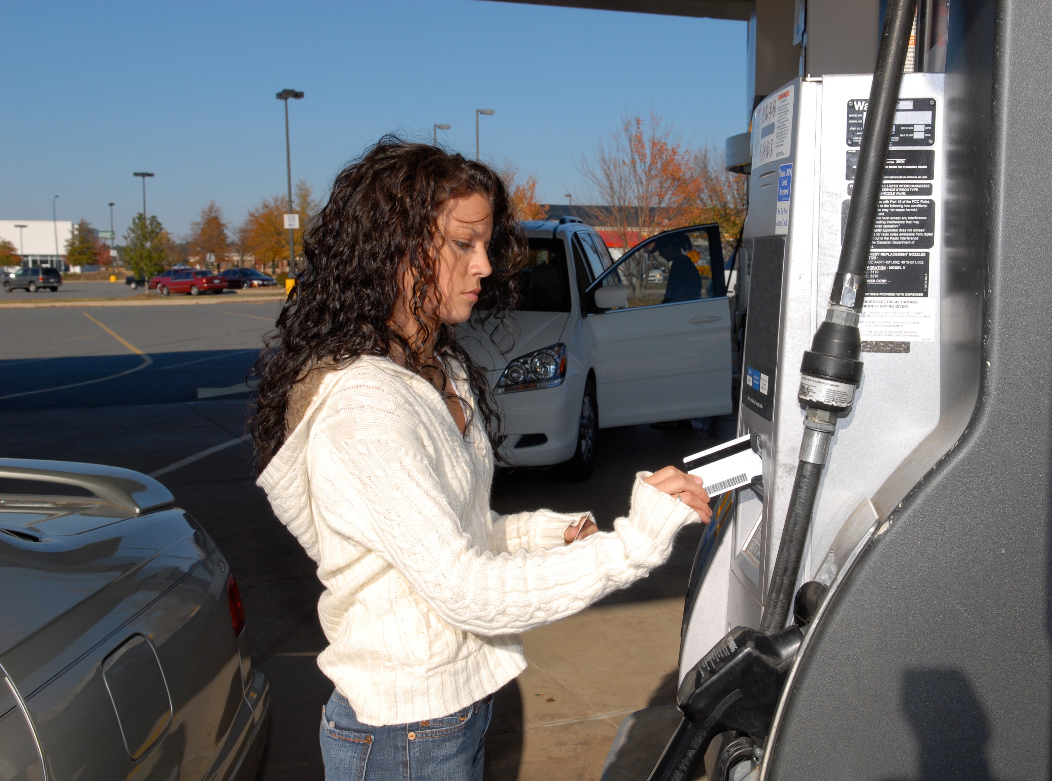 Woman paying for gas at fuel station