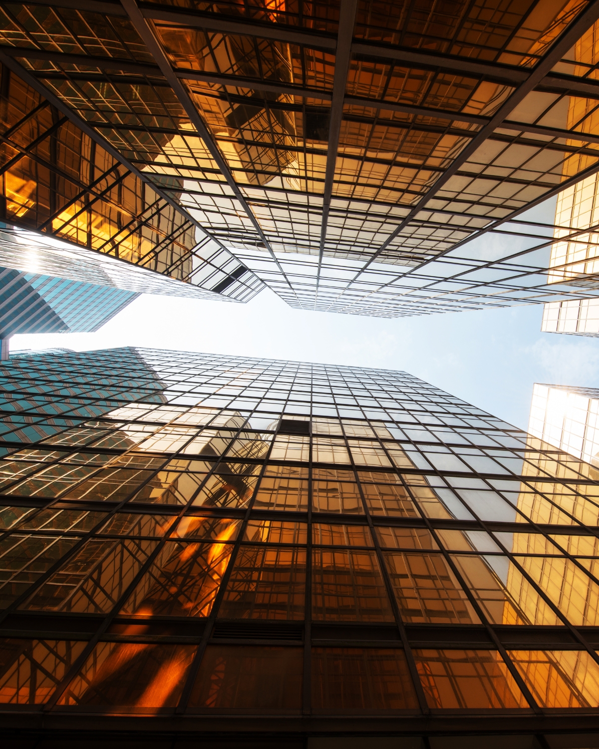 Looking up at glass office towers in a downtown business district