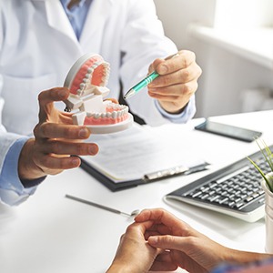 Dentist talking dental implants with patient