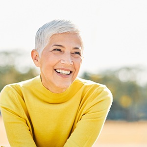 Older woman wearing yellow and smiling