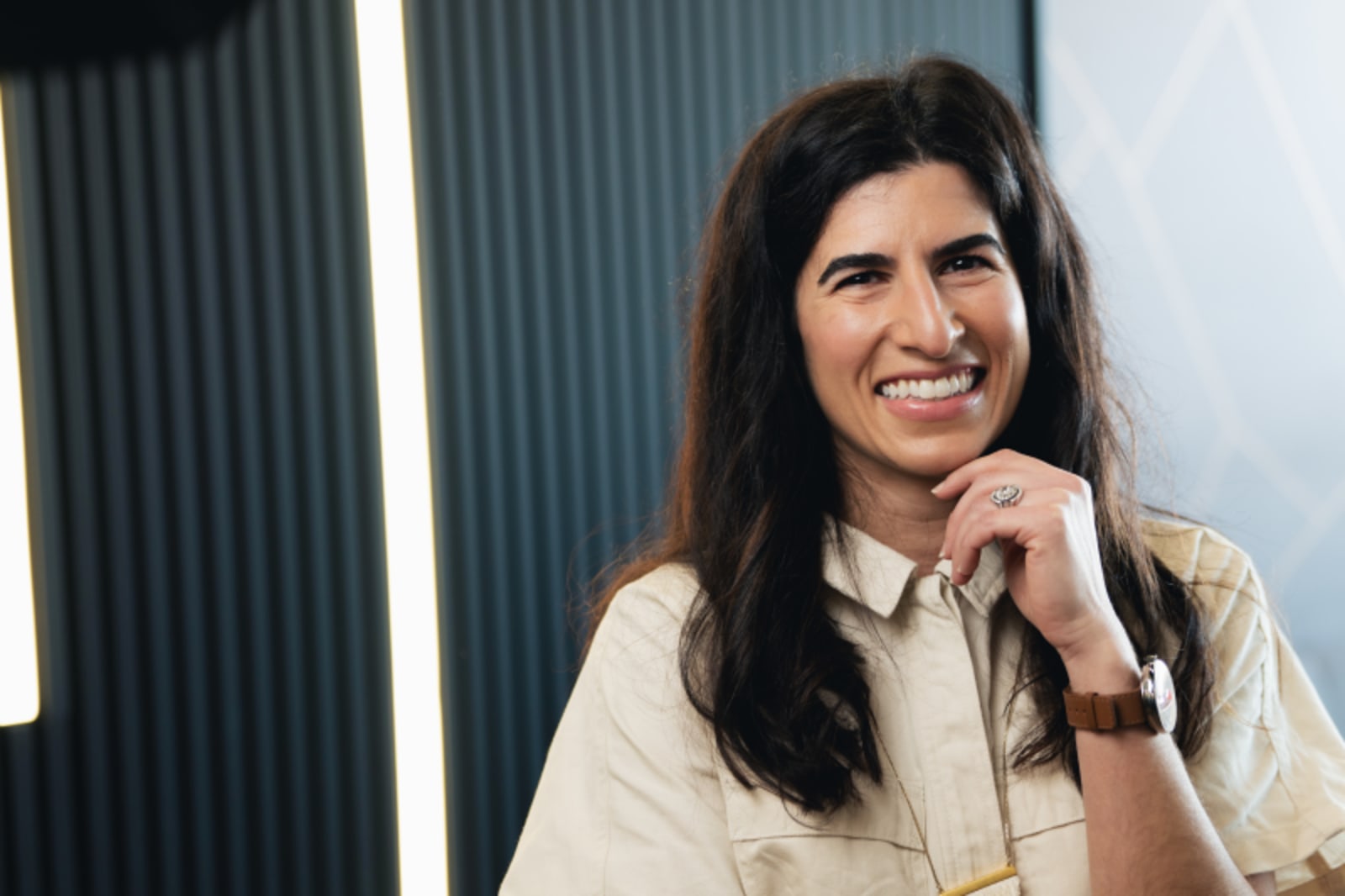 Woman smiling at camera in a bright dental office setting