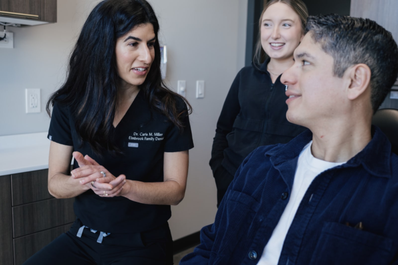 Elmbrook Family Dental dentist discussing Invisalign treatment with a patient in the office.