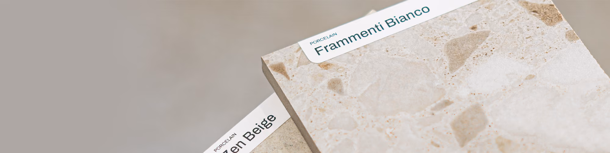 Two porcelain tile samples labeled Frammenti Bianco and Frozen Beige on a neutral background.