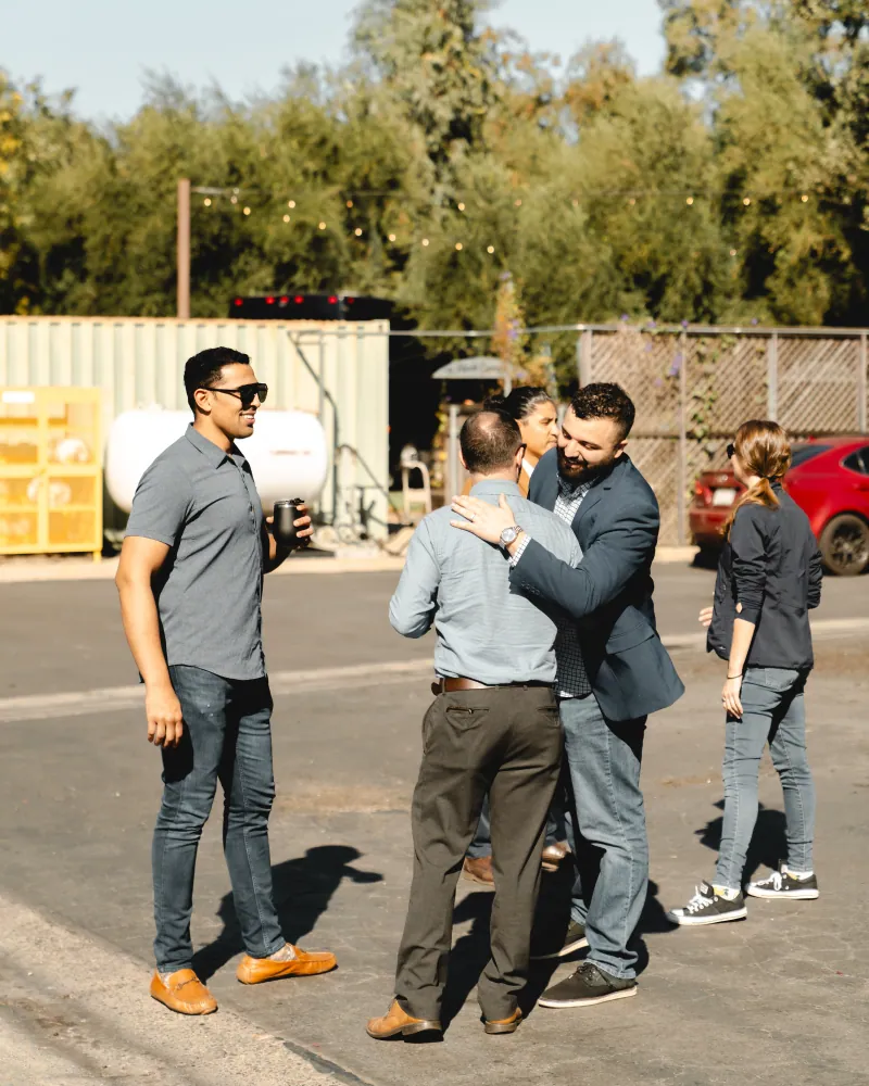 Attendees greet each other with a hug at a corridor tour stop