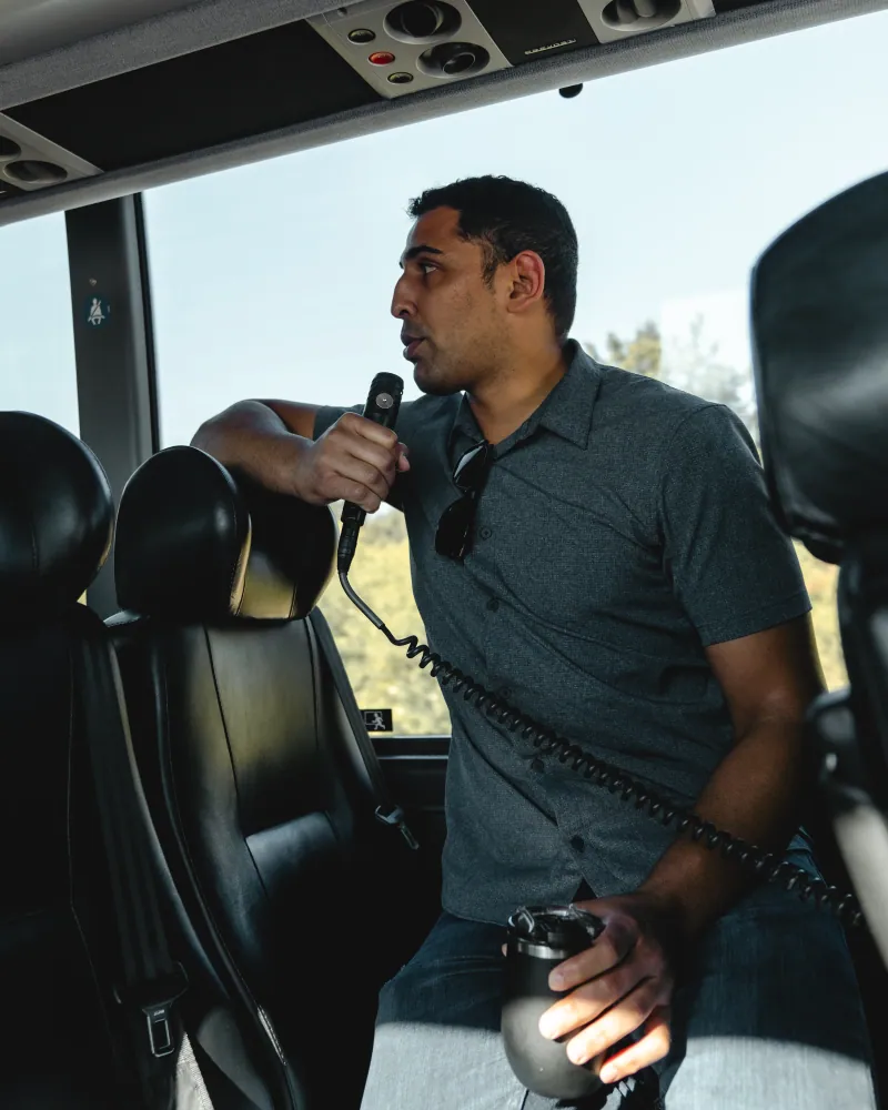 Corridor Tour Guide Speaking On Bus