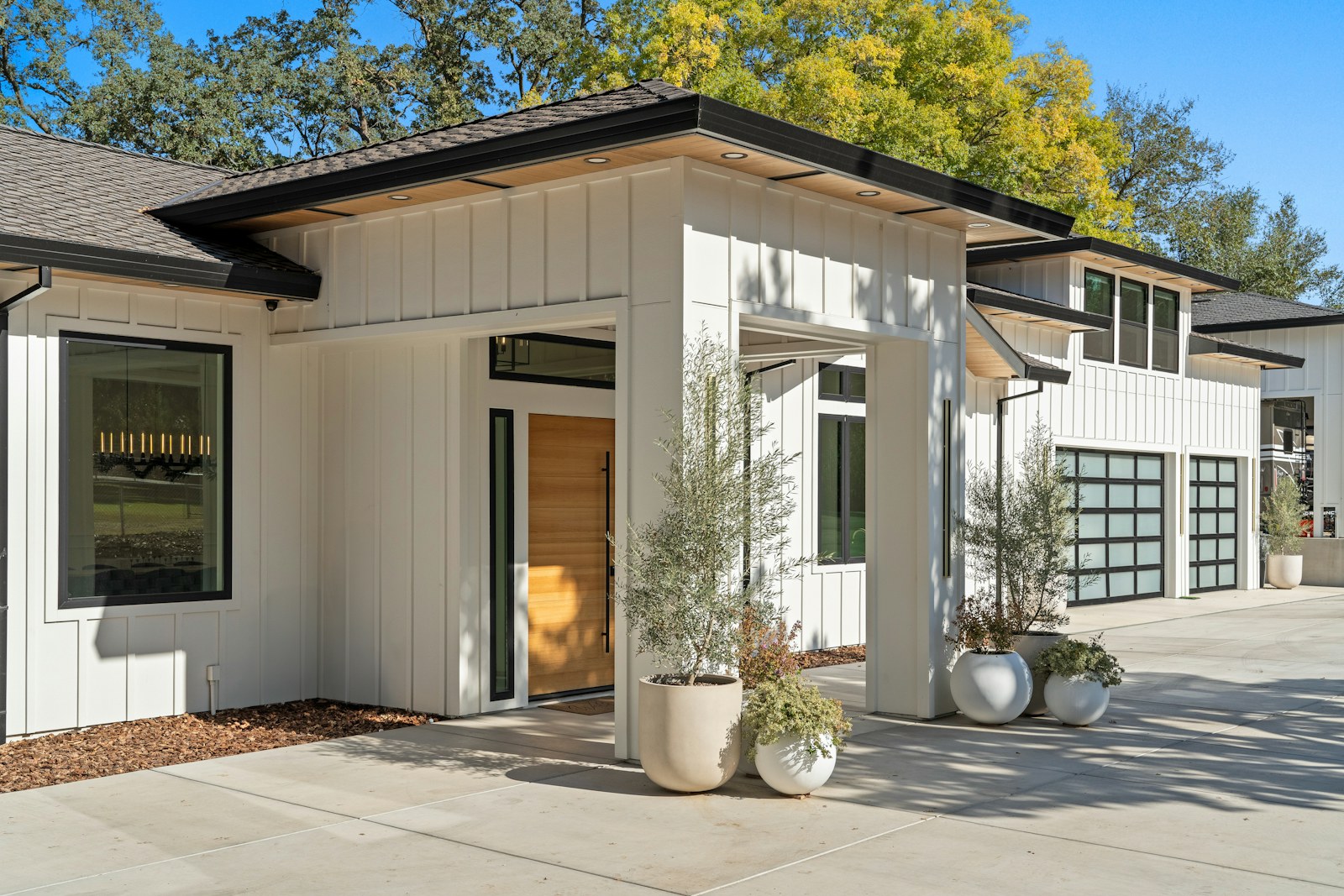 Modern farmhouse with olive trees at the entry