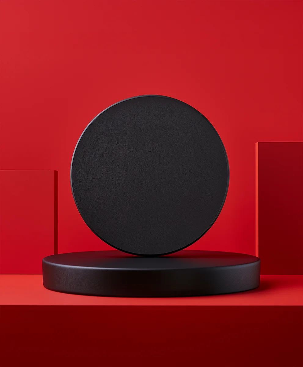 Black circle object on red minimal podium
