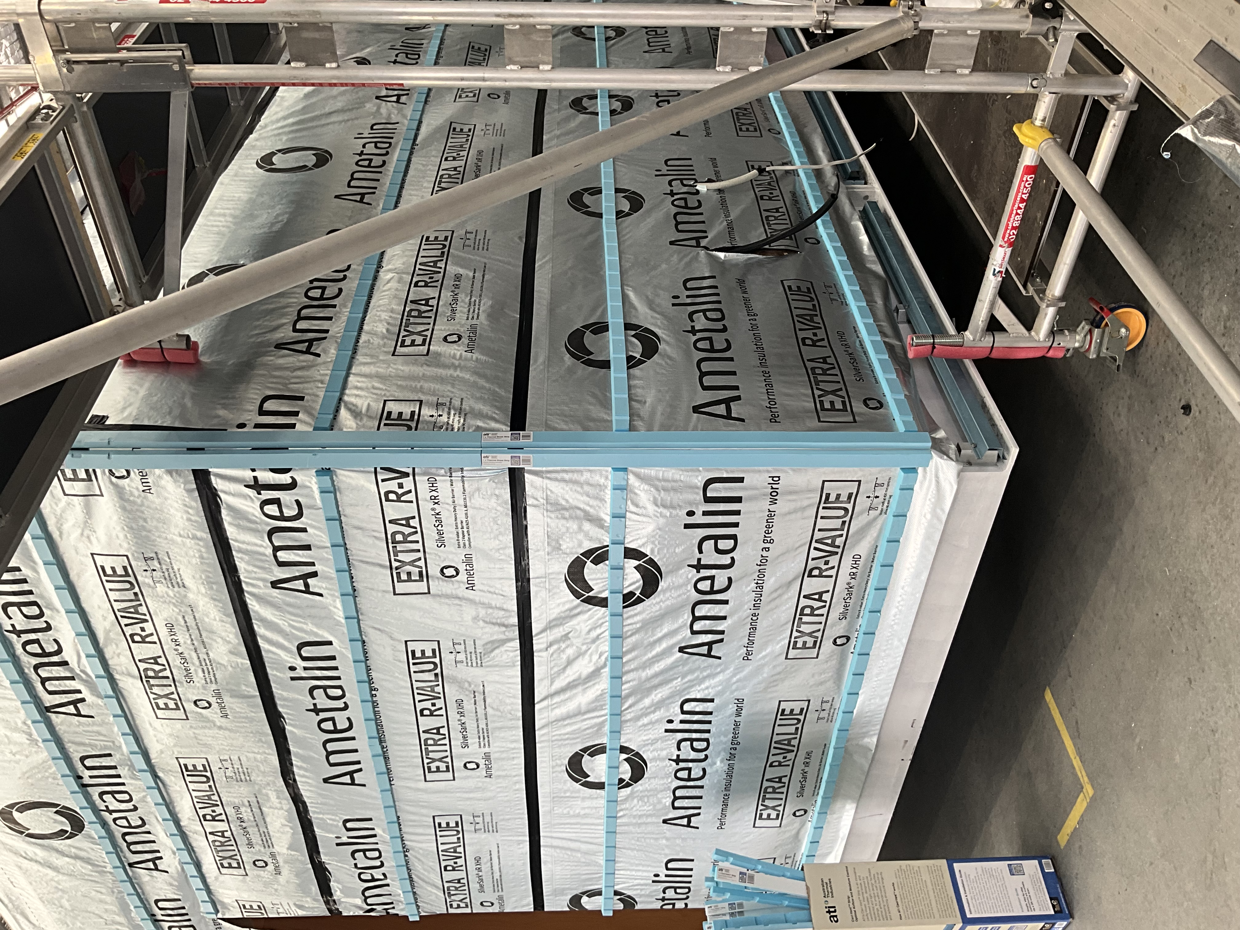 A wall wrapped in a building membrane with ATI cavity strips forming the drained and ventilated cavity