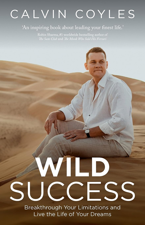 An image of a man sitting on the sand wearing a white shirt looking away from the camera with text that reads "Wild Success Breakthrough your limitations and live the life of your dreams" standing as a book cover
