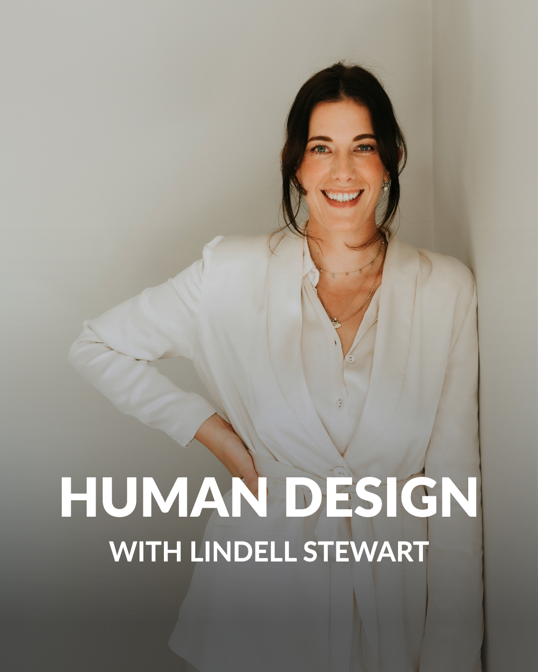Smiling woman in a white blazer standing against a light wall with text reading 'Human Design with Lindell Stewart'.