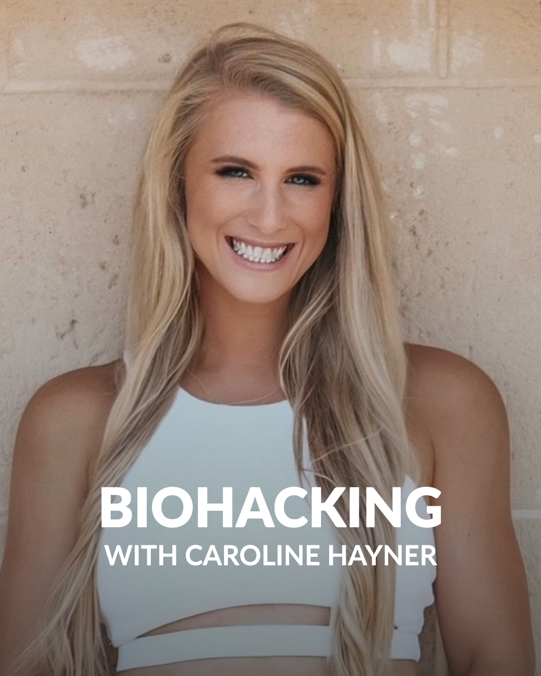 A woman wearing a white shirt smiling into the camera with text that reads "Wellness with Caroline Hayner"