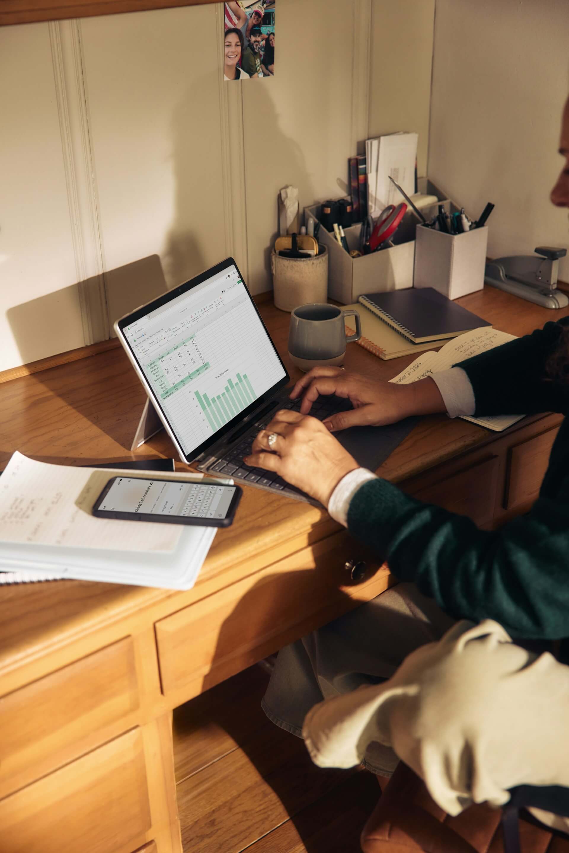 person using iPad with keyboard at desk