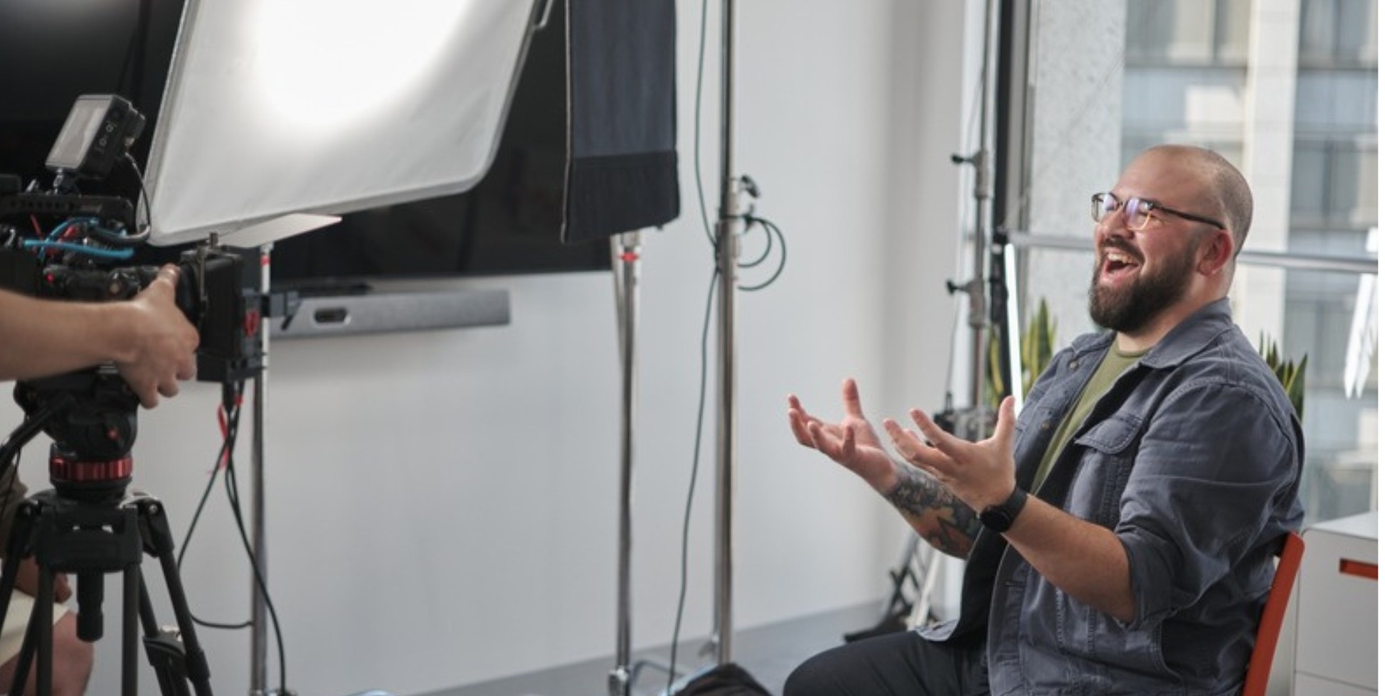 Sterling Chin laughing on camera during the NEEBA interview shoot at Postman Demo Day, 2022