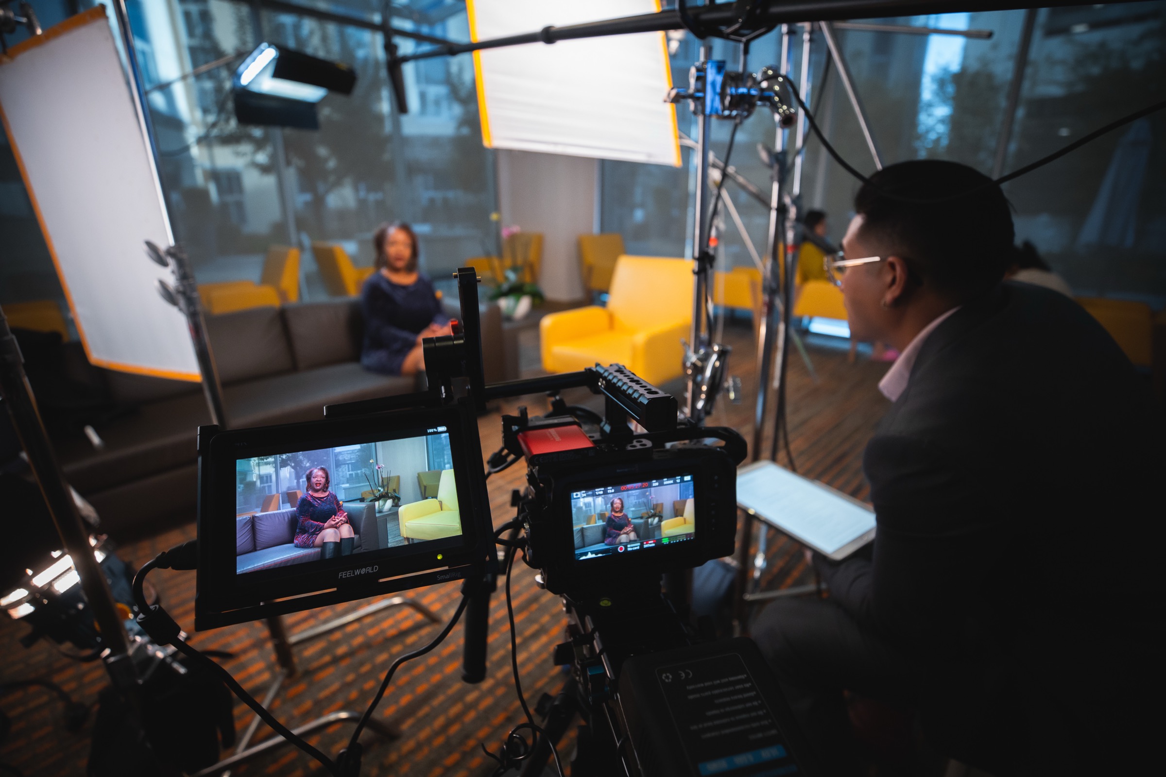 Camera monitors showing the live feed as Marlo Custodio directs a seated interview on a NEEBA set