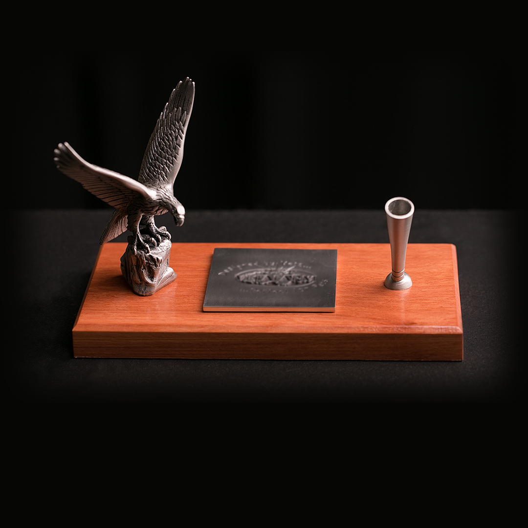 Custom pewter desk set featuring an eagle figure, pen holder and engraved plate mounted on a jarrah timber base