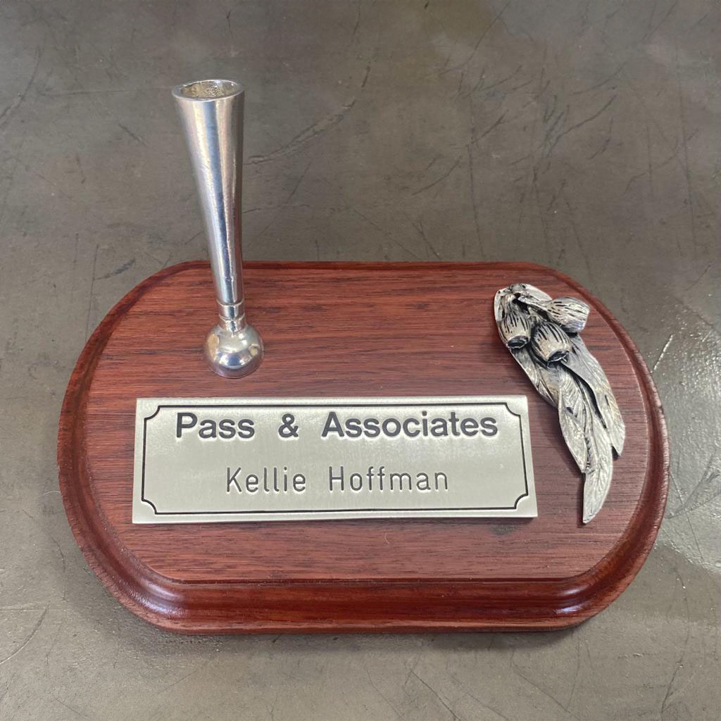 Custom pewter desk nameplate with pen holder and decorative pewter detail mounted on a timber base.