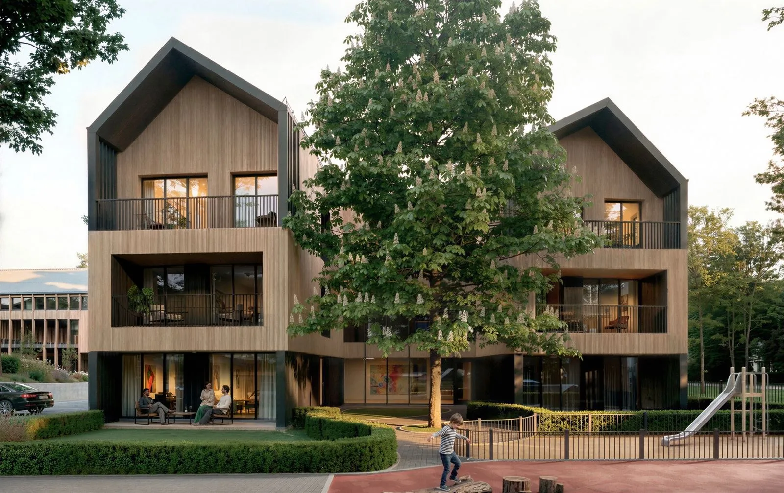 Modern multi-story wood house with balconies, tree in front, and child playing near playground slide.