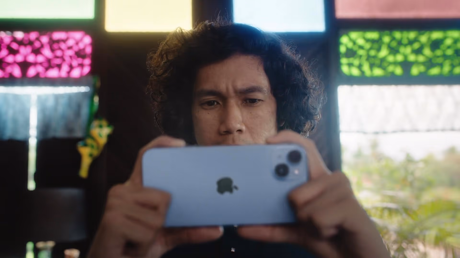 holding apple phone camera